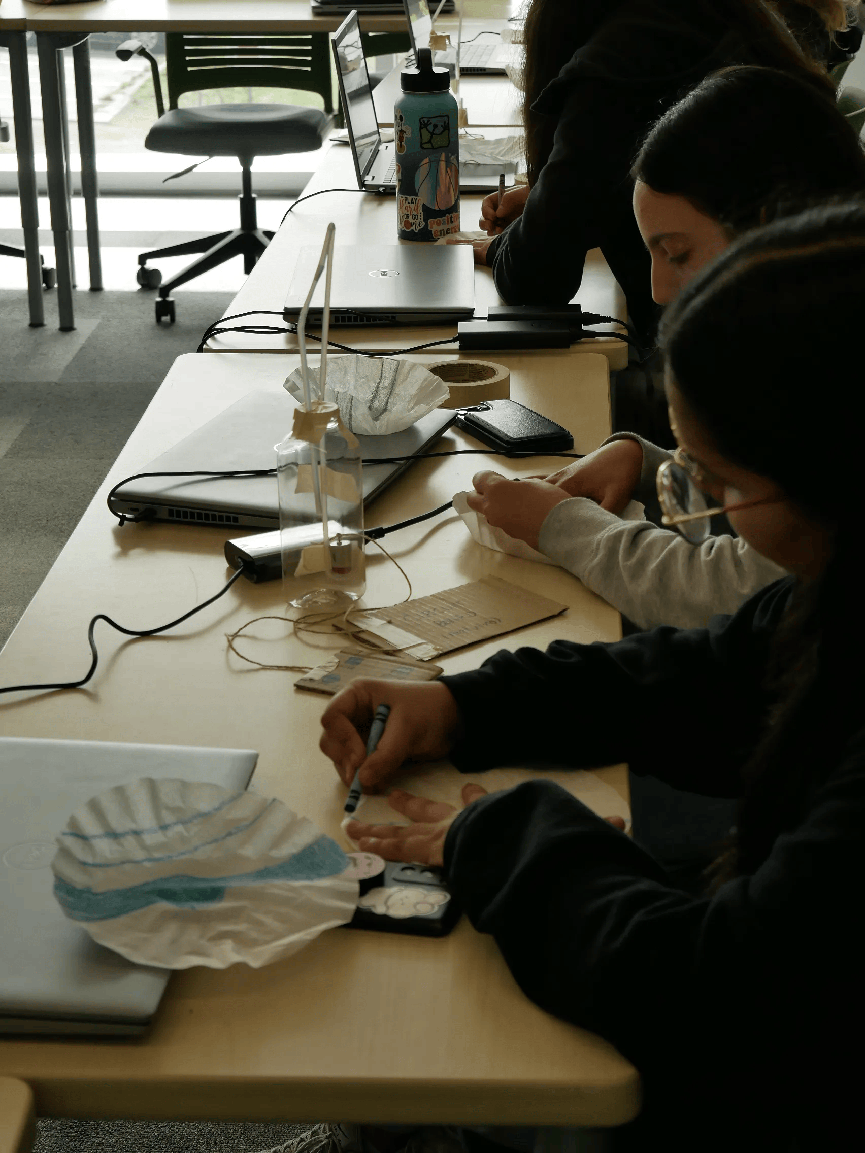 Geering Up students creating their microfluidic chip models using filter paper and crayons.
